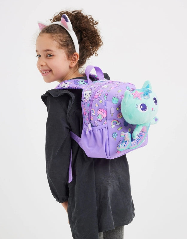 Girl wearing a purple Smiggle Gabby’s Dollhouse Nursery Backpack with a removable plush mermaid cat toy.
